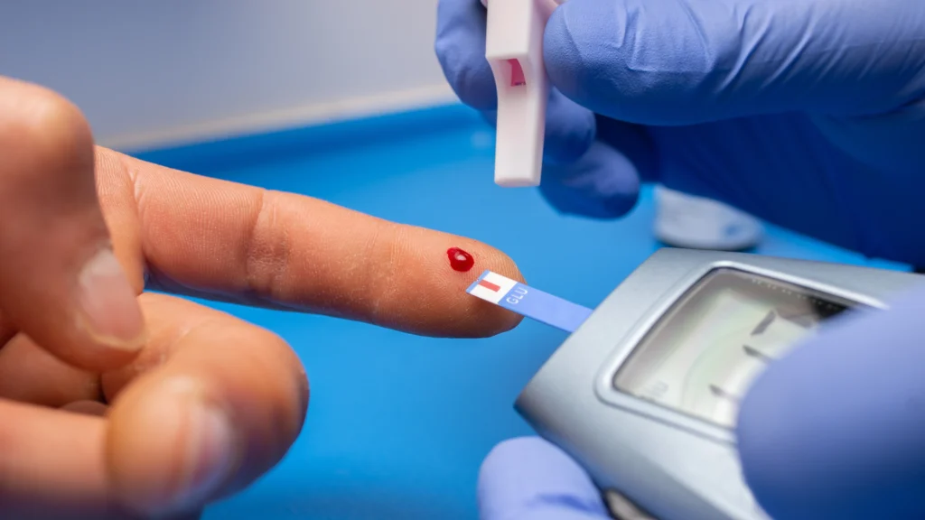 A healthcare professional using a blood glucose meter to test blood sugar levels, highlighting the importance of understanding nutritional value and its impact on health