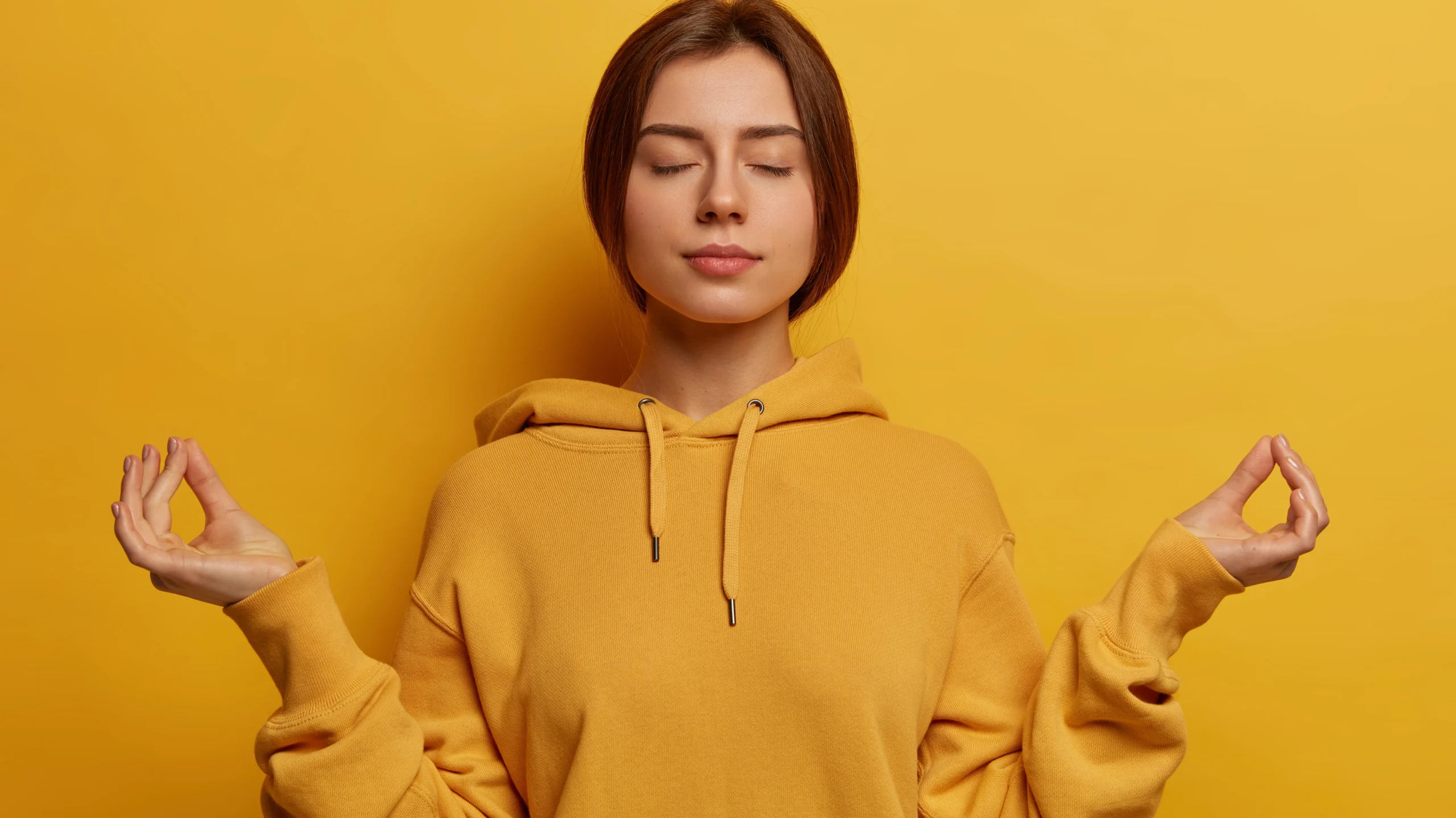 A young woman with a genuine, radiant smile and warm, confident gaze looks directly at the camera, her relaxed posture and soft natural lighting evoking approachability and inner calm—a visual invitation to reflect on 'What is mental health' and the importance of emotional well-being, self-acceptance, and open dialogue